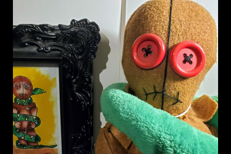 Close up of doll with framed print